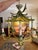 Vintage Hollywood Regency faux bamboo pagoda chandelier featuring hand-painted tropical parrot accents and whimsical...