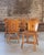 Solid pine dining chairs with sculptural keyhole cut-out backrests and softly contoured top rails, likely produced in the...