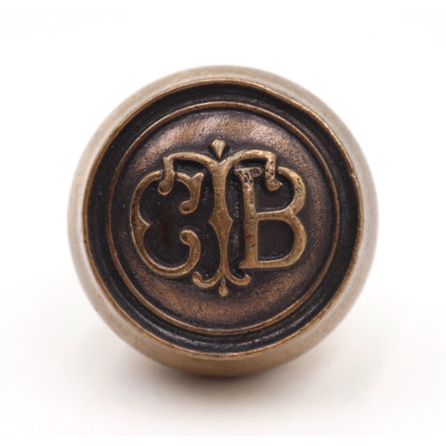 Bronze CTB emblem passage door knob with a patina finish. The manufacturer and date of creation is unknown. During the...