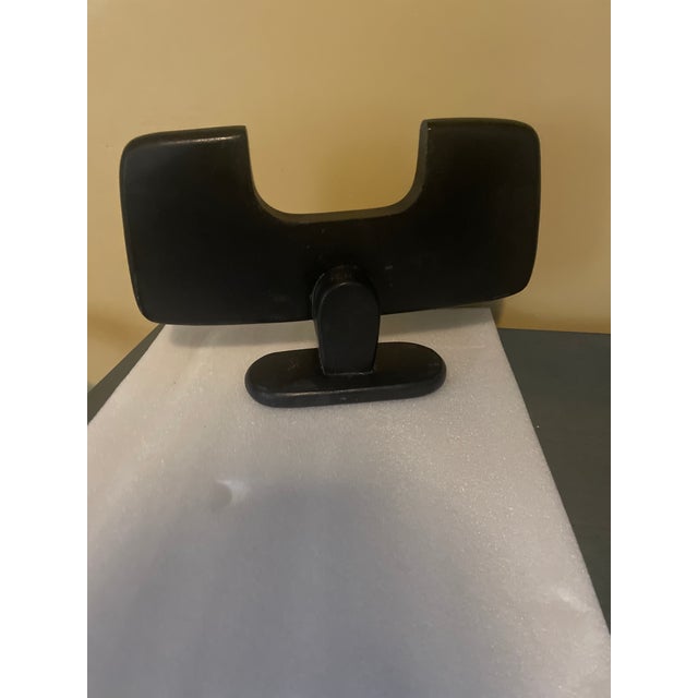 Carved from natural wood and finished in a sleek matte black, this piece captures the raw power and dynamic energy of the...