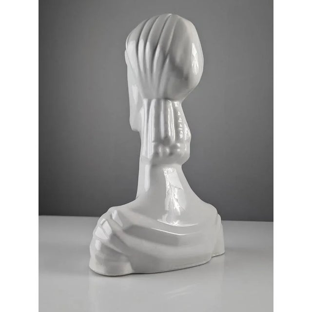 Ceramic sculpture of a female bust with elegant straight and elongated features that make it a very interesting and...