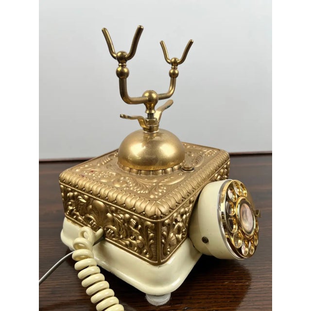 Vintage French Style Brass Rotary Telephone with Ornate Repoussé Cream Enamel Ba Add a touch of Hollywood Regency glamour...