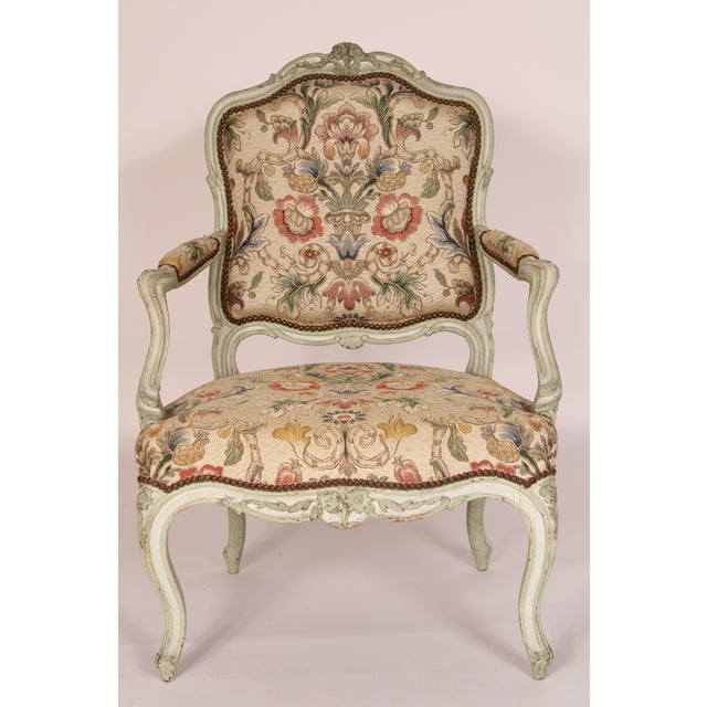 Pair of antique painted Louis XV style armchairs, late 19th century. With floral carved cupids bow crest rails,...