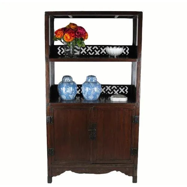 This large cabinet displays masterfully carved lattice railings, offering a distinctive Asian style with a high level of...