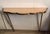 An elegant Italian wall-mounted console table from the 1940s, crafted from solid brass with a pink mirrored glass top,...