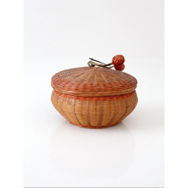 A mid-century Chinese lidded basket with a finely woven form and rounded silhouette. The fitted lid is topped with a...