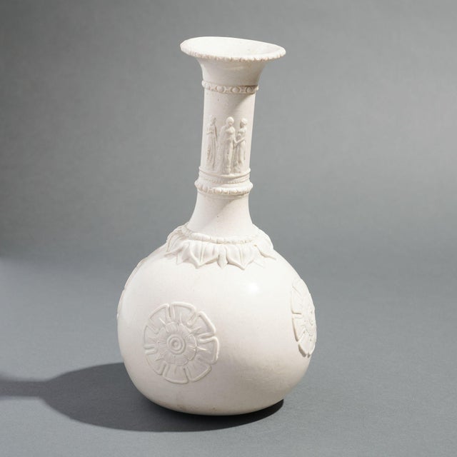 Salt glazed white stoneware water bottle with molded Neoclassic decoration on an archaic bottle form. G.R. Booth produced...