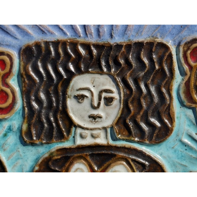 A beautiful figurative relief work, Modernist, Rustic-Modern, stylized representation of a woman wearing a stylized Breton...