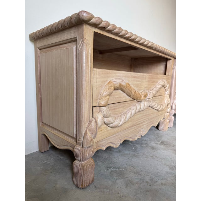 Striking pair of 1980’s vintage Hollywood Regency–style carved wood commodes featuring dramatic rope-twist motifs across...