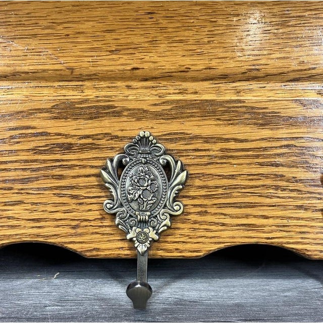 A charming Vintage French oak coat hanger, offering warm character and beautifully crafted detailing. Its scalloped base,...