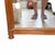 A Mid-20th Century Louis XVI style trumeau mirror featuring a fruitwood frame with decorative garland appliques. Style:...