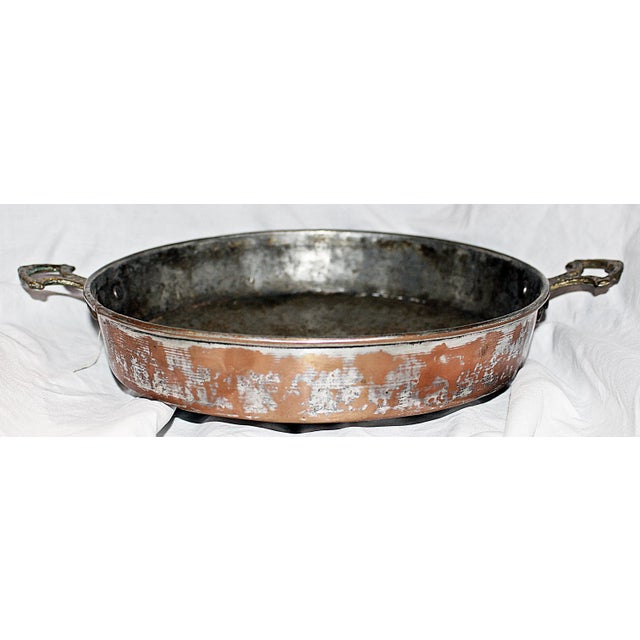 Antique copper saute' pan, tin lined with hand-cast brass handles. Typical wear as seen.