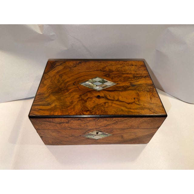 This listing is for an antique wooden box with pearl inlay. The box was originally meant to be used as a sewing box, but...