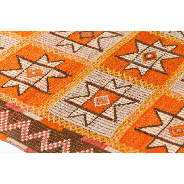 This is a vintage Turkish Oushak rug from the Mid 20th Century. The piece was hand-knotted.