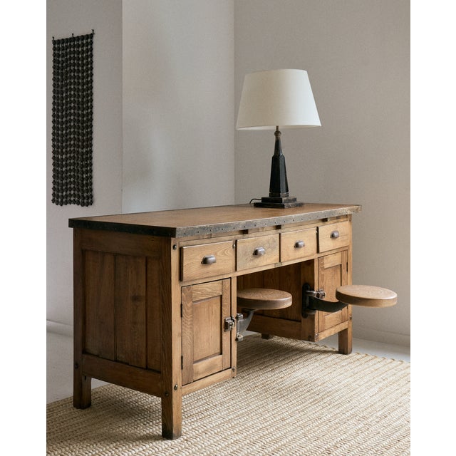 Early 20th century industrial wood and metal desk with two (2) integrated swing out stools by E.H. Sheldon & Co. Sometimes...