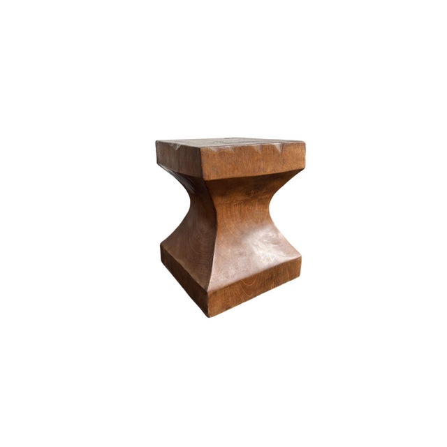 Handcrafted from reclaimed solid teak wood, this sculptural side table is defined by its bold architectural form and the...