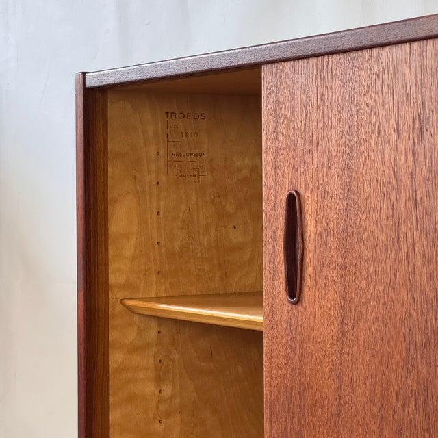 Elegant mid-century sideboard designed by nils jonsson for troeds in the 1960s. Crafted in teak with clean lines and...