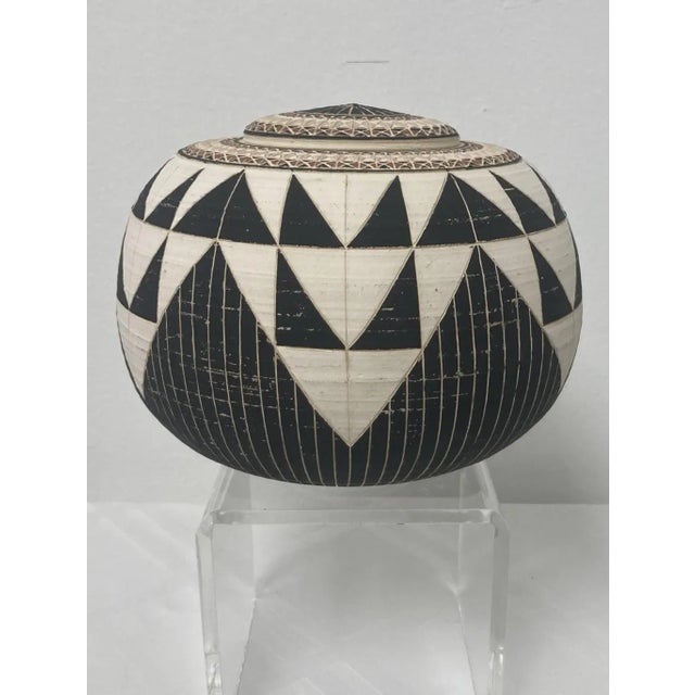 Round in plan view whiteware ceramic vessel with lid, signed Landing Pots 1988 (artists Madeline Landing & Robert Massaro)...