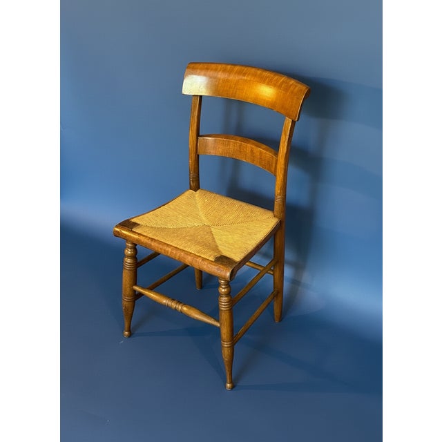 Set of six 19th century Sheraton Birds Eye Maple dining chairs featuring curved ladder backs and woven rush seats....