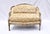 French Louis XvI Style Marquise Bergere Loveseat & Ottoman with distinct design elements of the period including hand-...