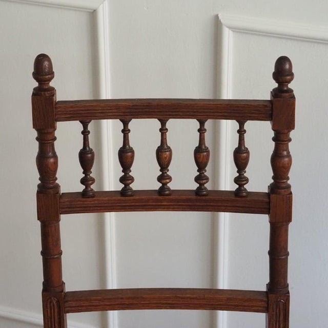 A pair of antique oak chairs with Viennese wickerwork, stylistically dating to around 1900 with echoes of late French...