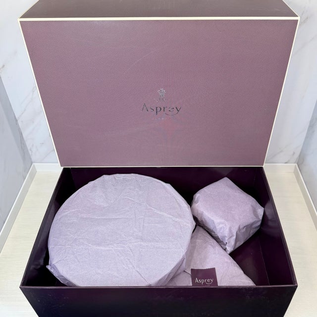 An elegant Asprey London caviar service set featuring a substantial crystal outer bowl with a sterling silver (925) Asprey...