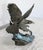 Beautiful pewter work by Paul Brunelle, representing a North American fish eagle spreading its wings and swooping down on...