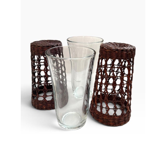 Vintage set of two clear glass tumblers with beautifully woven dark brown wicker sleeves. Each glass features a removable...