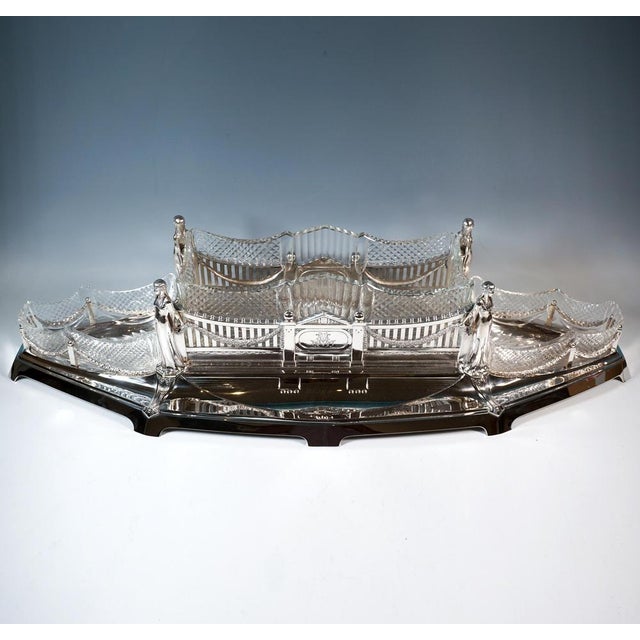 Elegant, festive silver vessel with a three-part architectural design: elongated boat-shaped base with low, flared sides,...