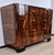 An imposing Venetian Art Deco dresser made entirely of walnut burl. It stands out for its two side doors, separated by two...
