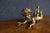 Antique Italian cherub sculpture depicting a reclining winged putto with curly hair and an outstretched pose. The figure...