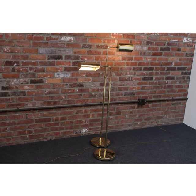 Pair of modernist polished brass floor lamps by Chapman (ca. 1970s, USA). Versatile in style and application featuring...