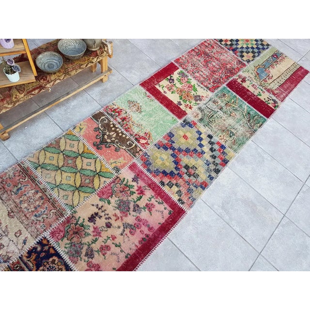 This is a vintage Turkish Oushak rug from the Mid 20th Century. The piece was hand-knotted.