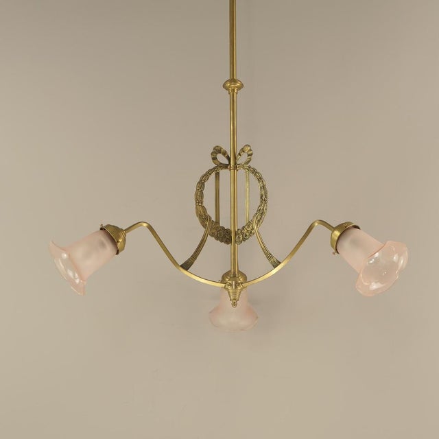 Brass chandelier with mouth-blown shades. The light provides a pleasant, glare-free light. Polished surface. The luminaire...