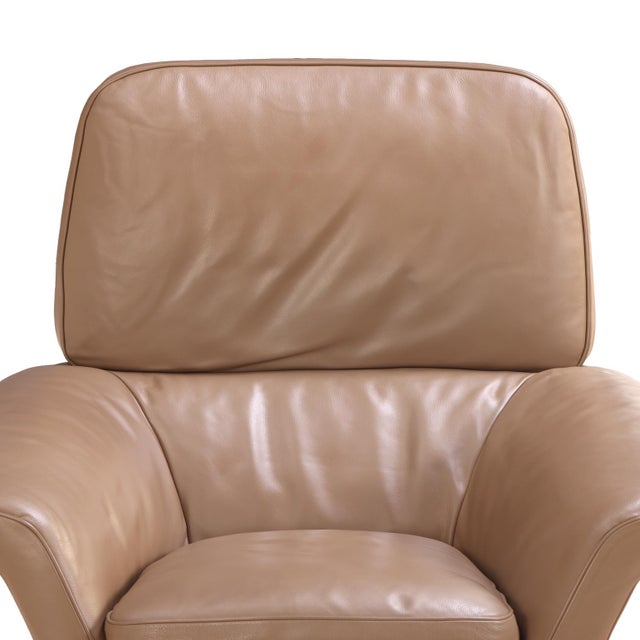 Contemporary Blake Soft chair and ottoman by Minotti, upholstered in supple tan leather with polished chrome bases. The...