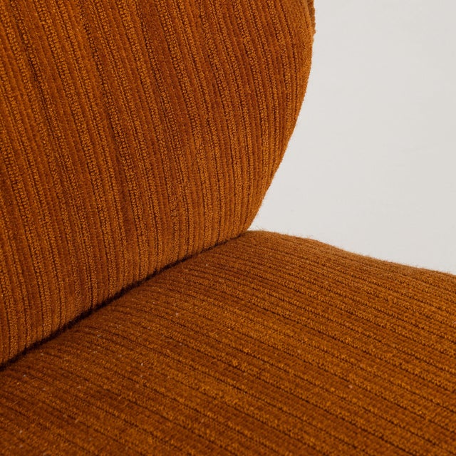 This set of 3 lounge chairs carries genuine presence, its burnt orange/rust upholstery, tapered wood legs immediately...