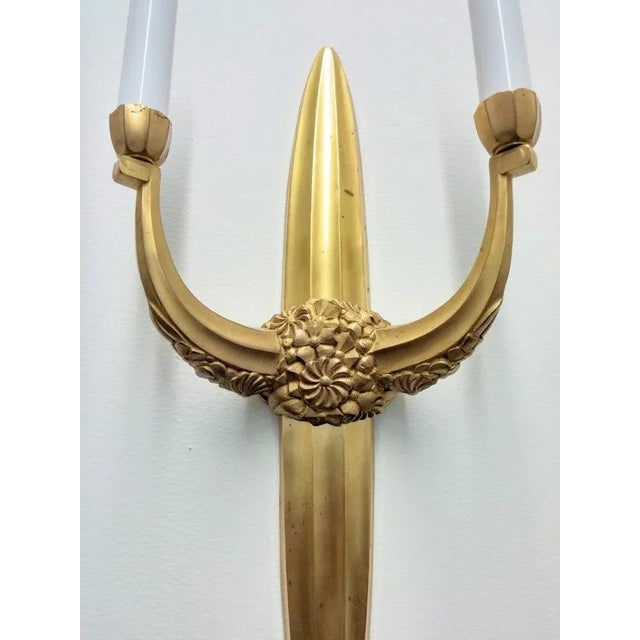 These stunning gold pair of French Art Deco style wall sconces are attributed to “Sue et Mare”. Each sconce elongated...