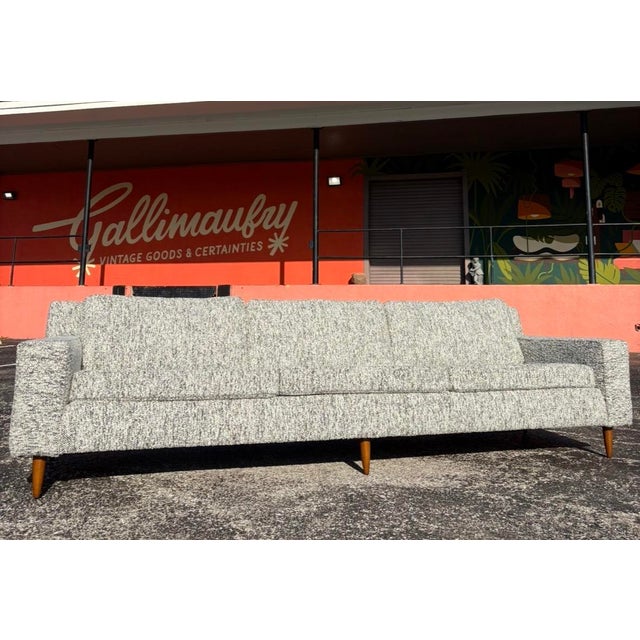 A beautiful, classic sofa redone in nubby salt and pepper with refinished tapered legs. The pitch of the frame is great in...