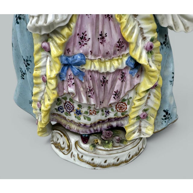 Stunning and extremely fine quality Dresden style Rococo female figure depicting an affluent lady holding a fan in stylish...