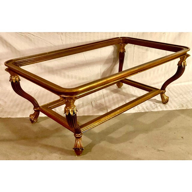 Maitland-Smith Gilded French Empire Style Coffee Table. Inset glass surface and lower shelf, gilded French Empire style...