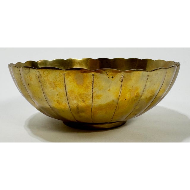 Vintage round brass bowl with decorative scallops along top rim and down sides. Would make a lovely candy bowl or display...