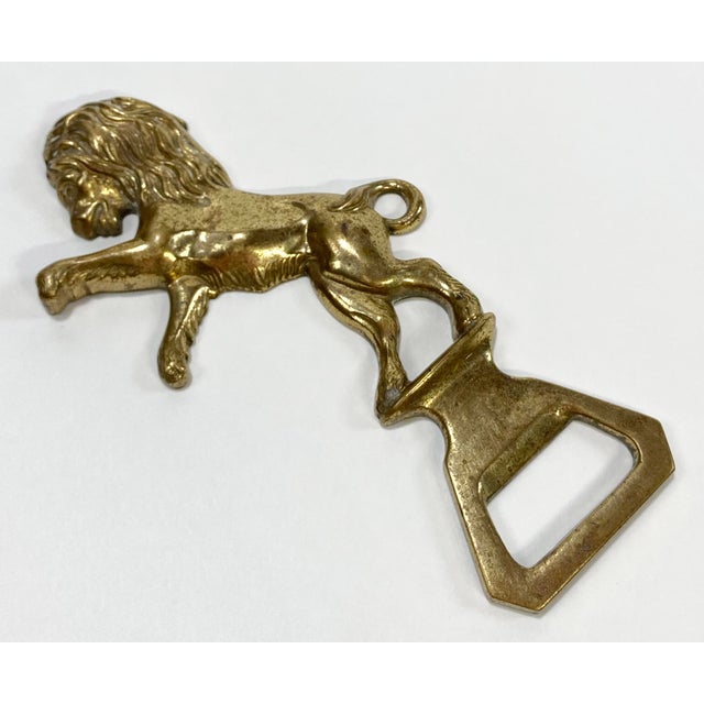 Vintage regal poised lion brass bottle opener. Wonderful conversation piece. Strong patina.