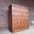 Belgian brutalist oak cabinet featuring a bold geometric paneled façade and hand-forged wrought iron strap hinges. The...