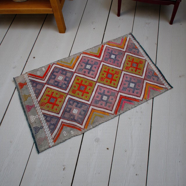 "This authentic vintage Turkish Cicim is a masterpiece of nomadic art, showcasing a sophisticated raised-pattern texture...