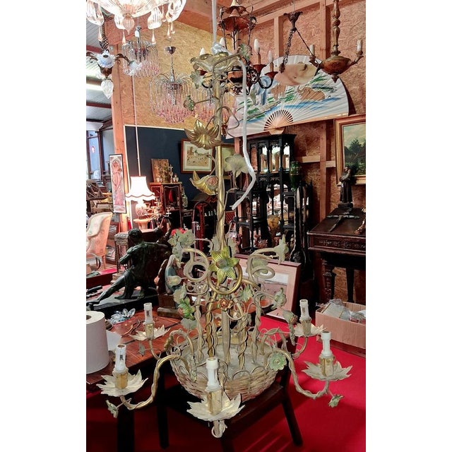 A spectacular chandelier with naturalistic decoration featuring an abundance of intertwined stems, blooming flowers, buds,...