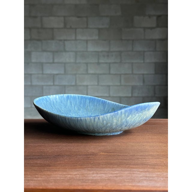 A large and uncommon bowl designed by Carl Harry Stålhane for Rörstrand. Features a wonderful baby blue and seafood color...