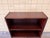 This vintage Danish bookcase features a refined design with an integrated glass display section, offering both storage and...