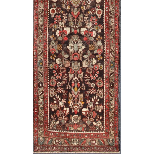 This Semi Vintage Hamedan gallery rug (circa mid-20th century) features a unique blend of colors and an intricately...