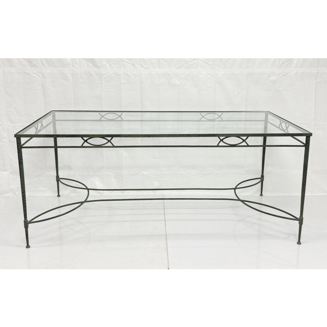 An elegant and highly collectible vintage wrought iron patio dining table designed by Mario Papperzini for Salterini,...