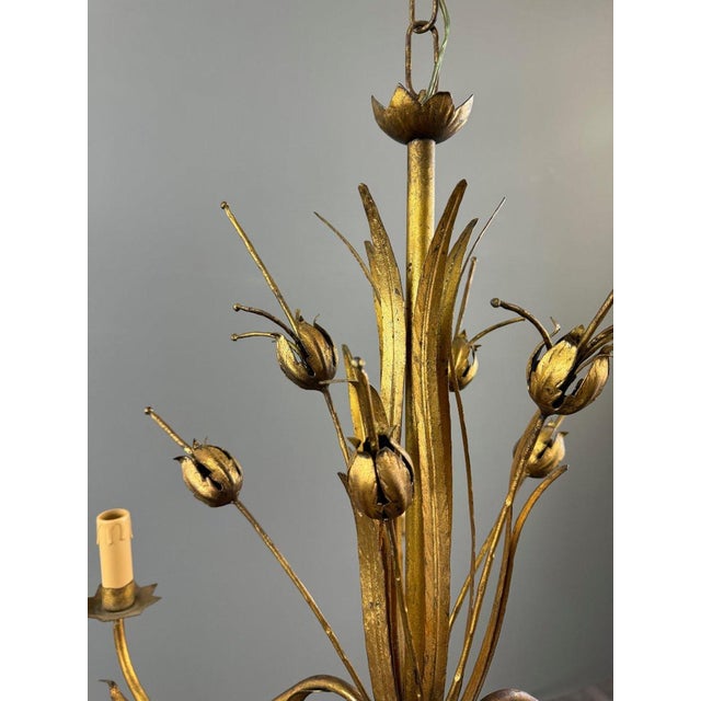 A superb Italian gilt metal chandelier with six lights, featuring an elegant floral motif typical of 1950s Italian design....